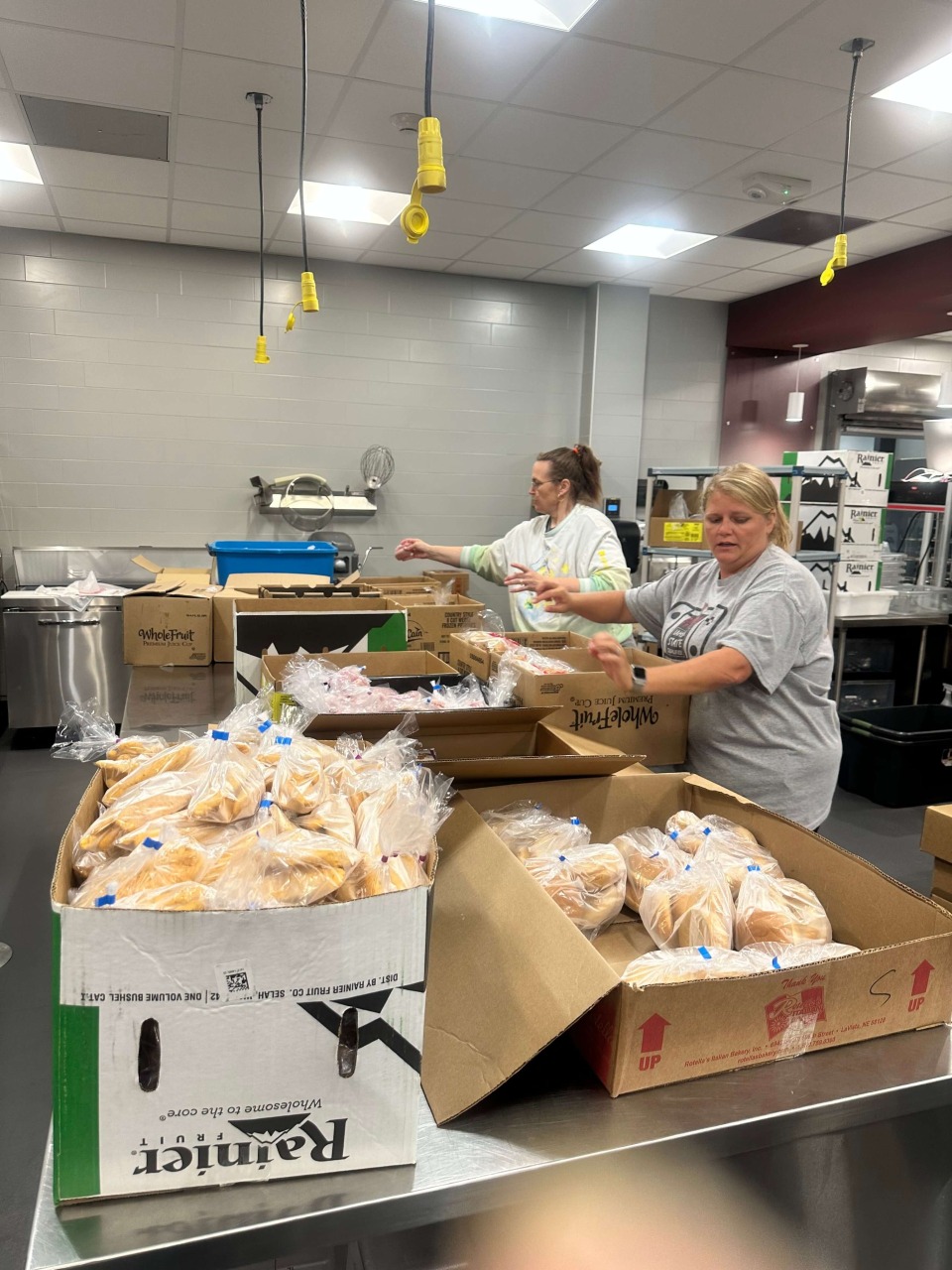 Team members putting together meals during the Cardinal CSD Summer Food Program.