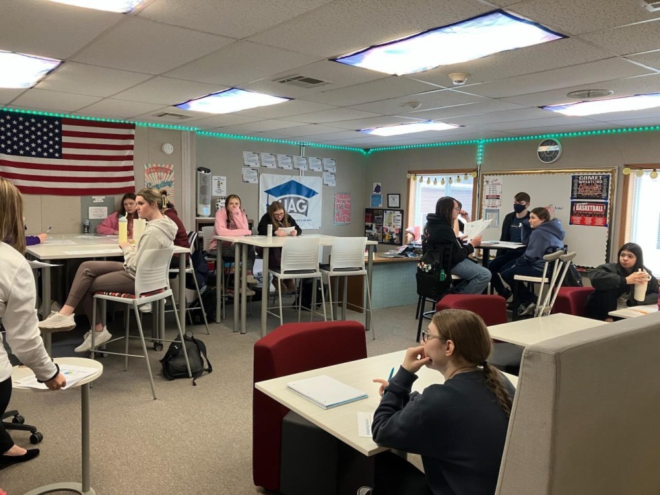 High school students attending a presentation on budgeting for the future.